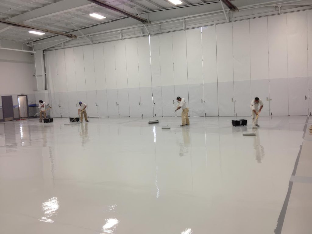 Gutierrez painting crew working across a large commercial interior